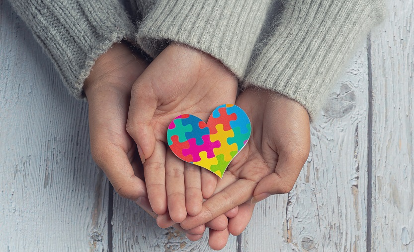 closeup on two young lovers holding hands at a table