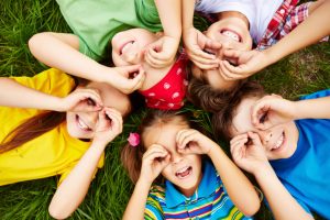 children playing on grass scaled e1656489527130